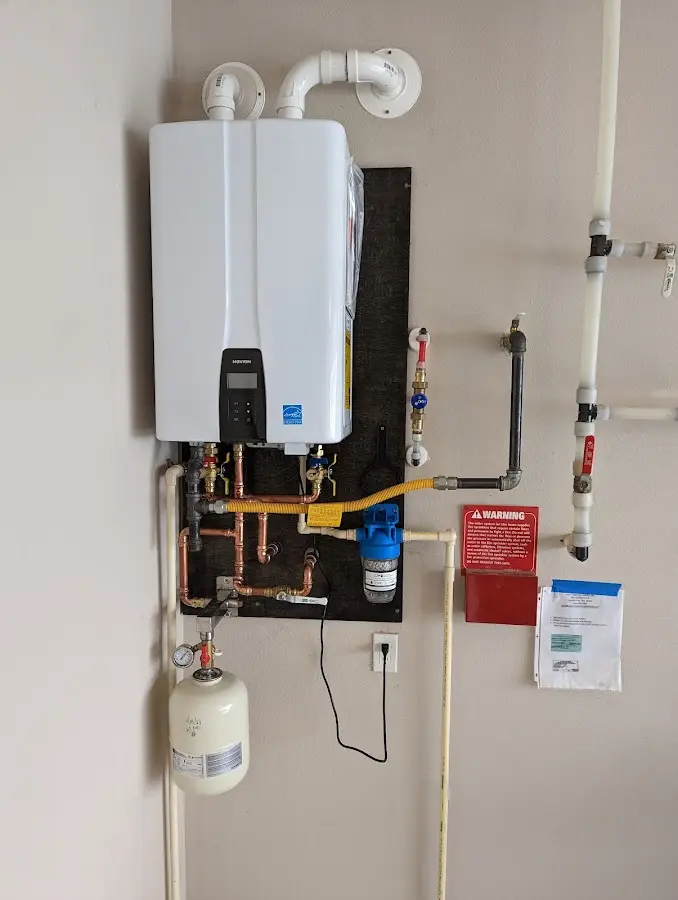 Professional plumber installing copper piping in a Mansfield home